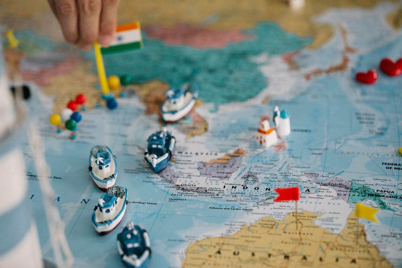World map with miniature ships and destination markers