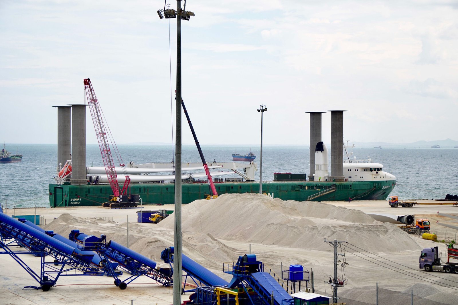 Cargo ship loading at an industrial port